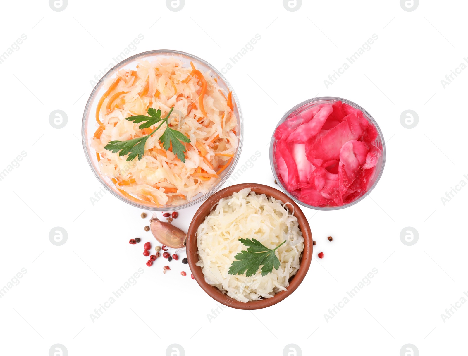 Photo of Delicious sauerkraut prepared according to different recipes and spices on white background, top view