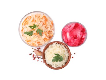 Photo of Delicious sauerkraut prepared according to different recipes and spices on white background, top view