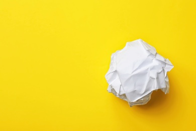 Crumpled sheet of paper on color background, top view. Space for text