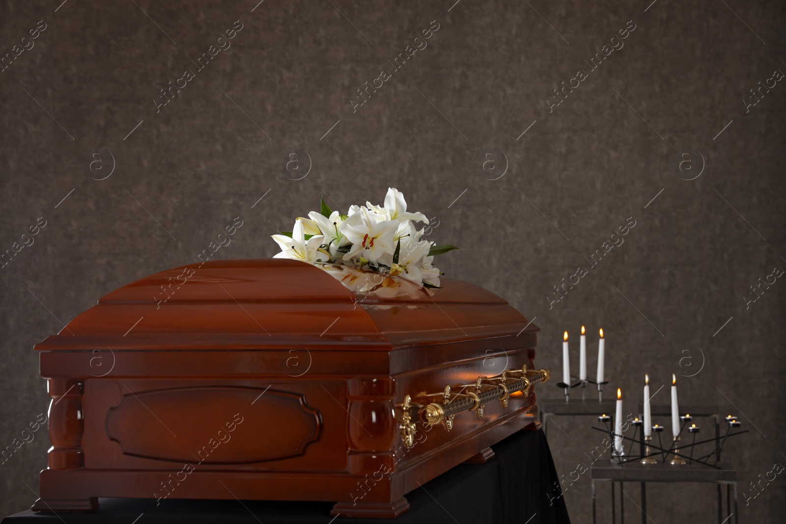 Photo of Wooden casket with white lilies in funeral home