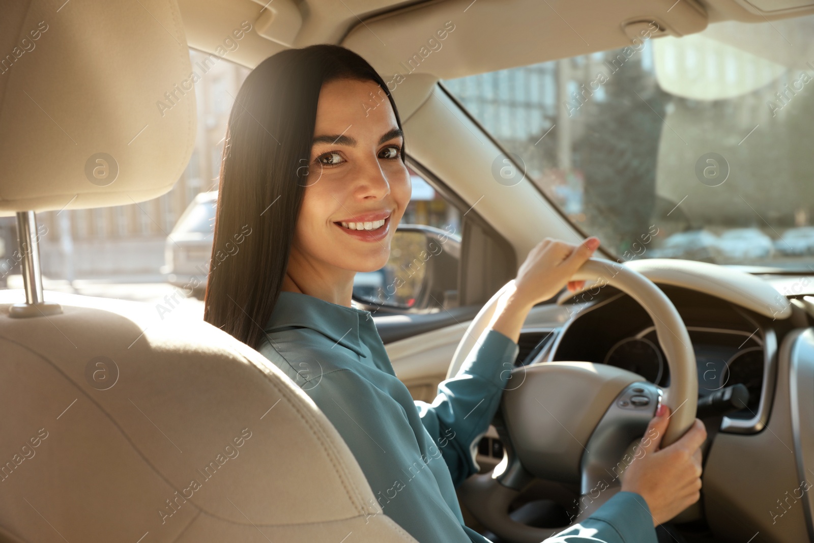 Photo of Beautiful young driver sitting in modern car