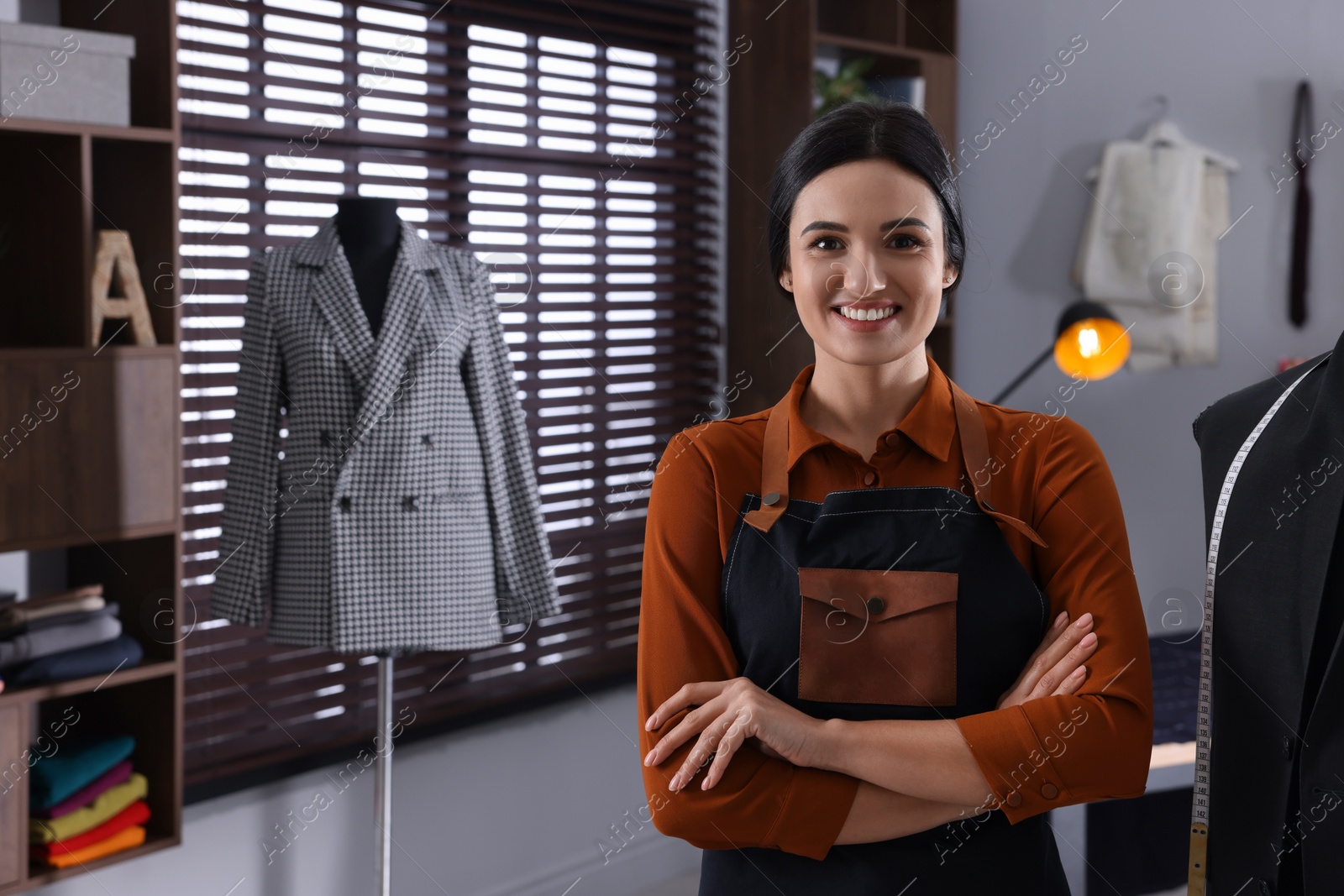 Photo of Happy dressmaker in workshop, space for text