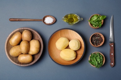 Flat lay composition with fresh organic potatoes on grey background