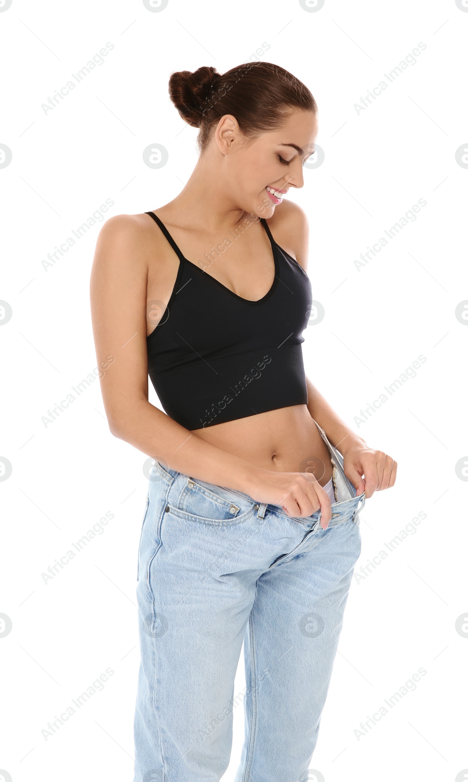 Photo of Slim woman in oversized jeans on white background. Weight loss