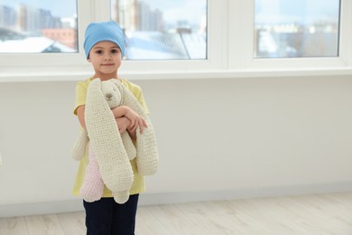 Photo of Childhood cancer. Girl with toy bunny in hospital