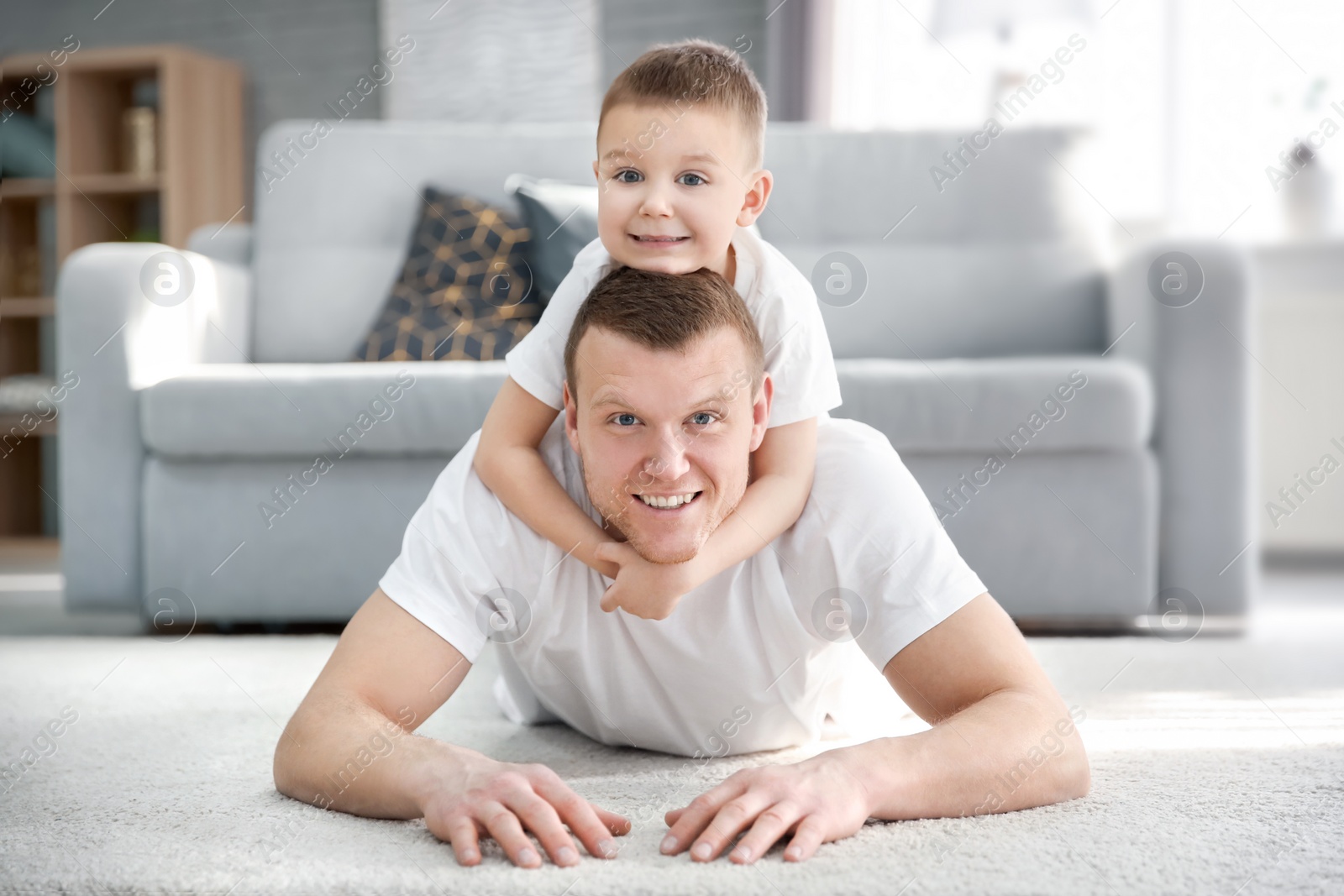 Photo of Happy dad and his son at home. Father's day celebration