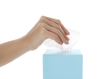 Photo of Woman taking paper tissue from box on white background, closeup