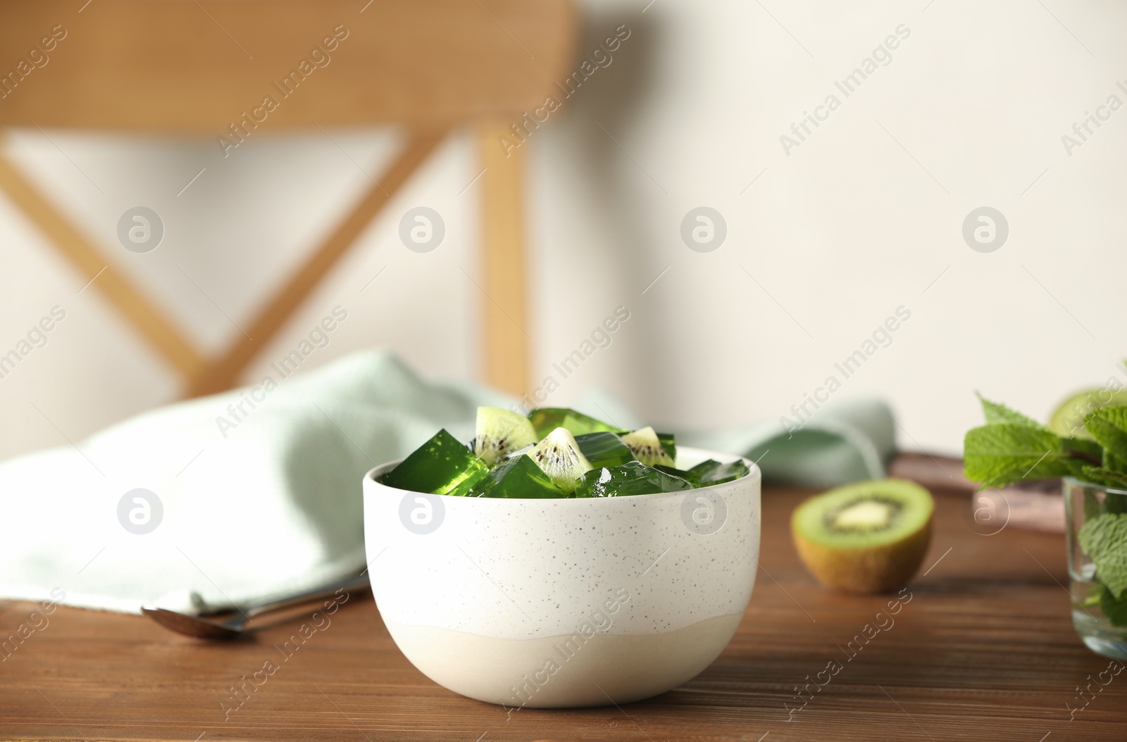 Photo of Bowl of tasty jelly on wooden table