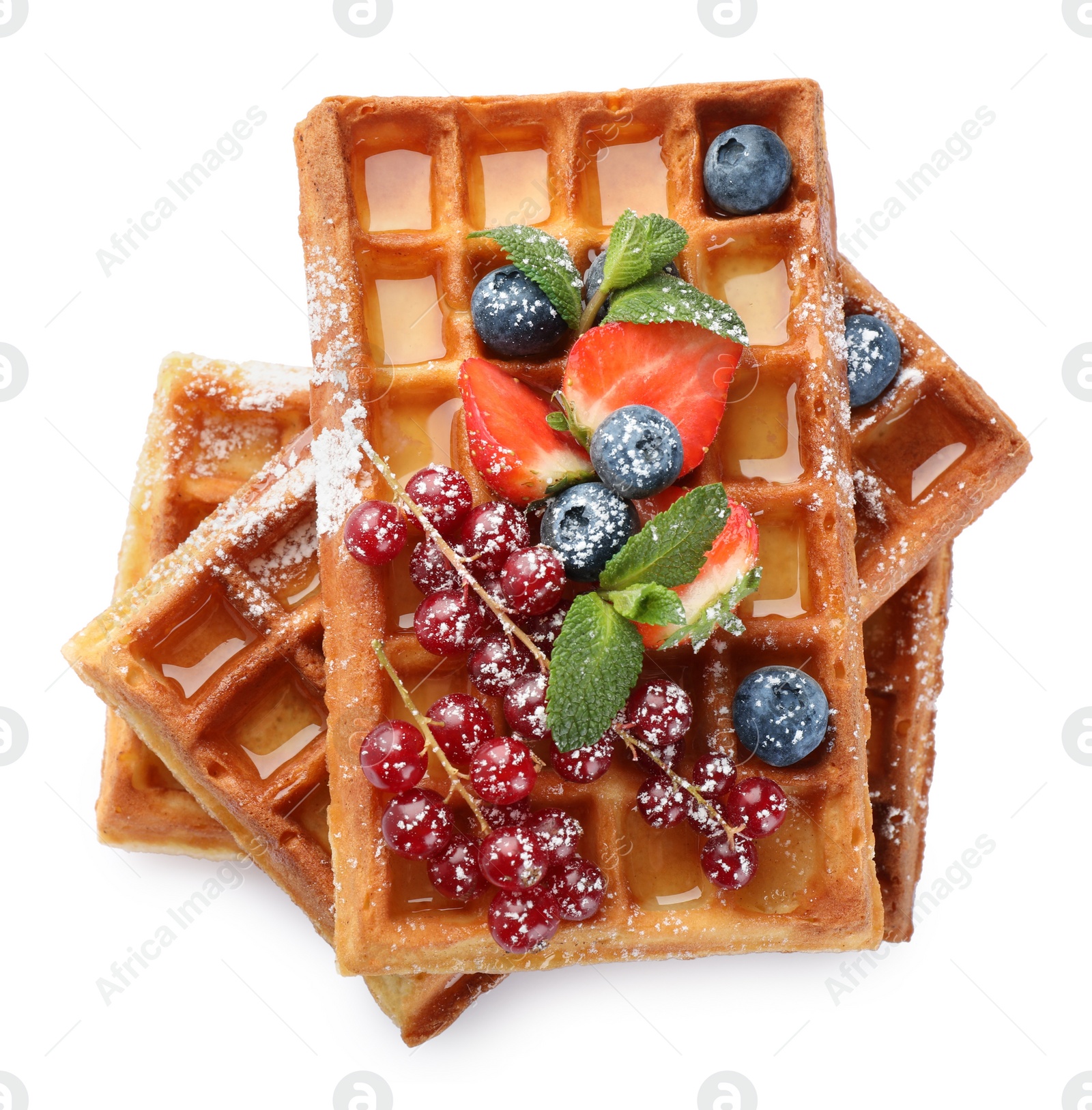 Photo of Delicious Belgian waffles with berries on white background, top view