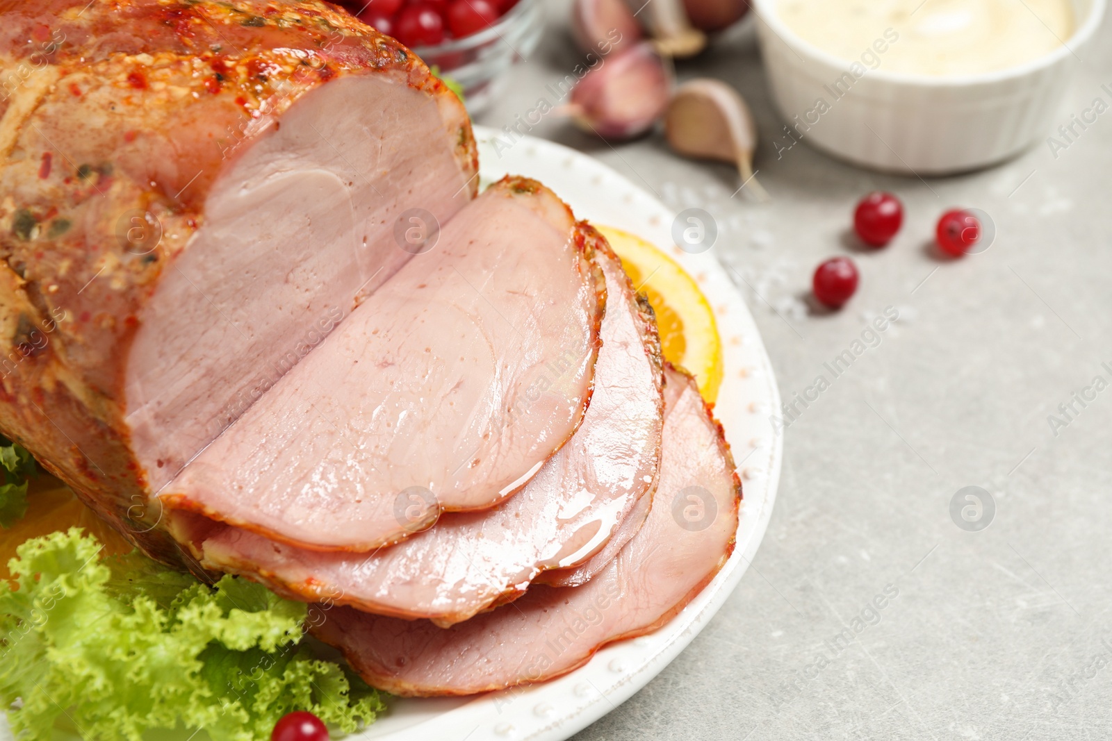 Photo of Delicious ham served with garnish on grey table, closeup