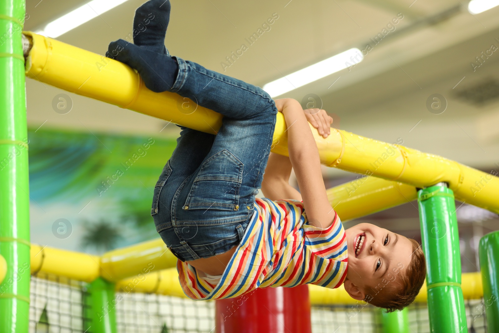 Photo of Cute little child playing at indoor amusement park