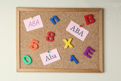 Photo of Applied behavior analysis concept. Paper notes with abbreviation ABA, colorful letters and numbers on corkboard