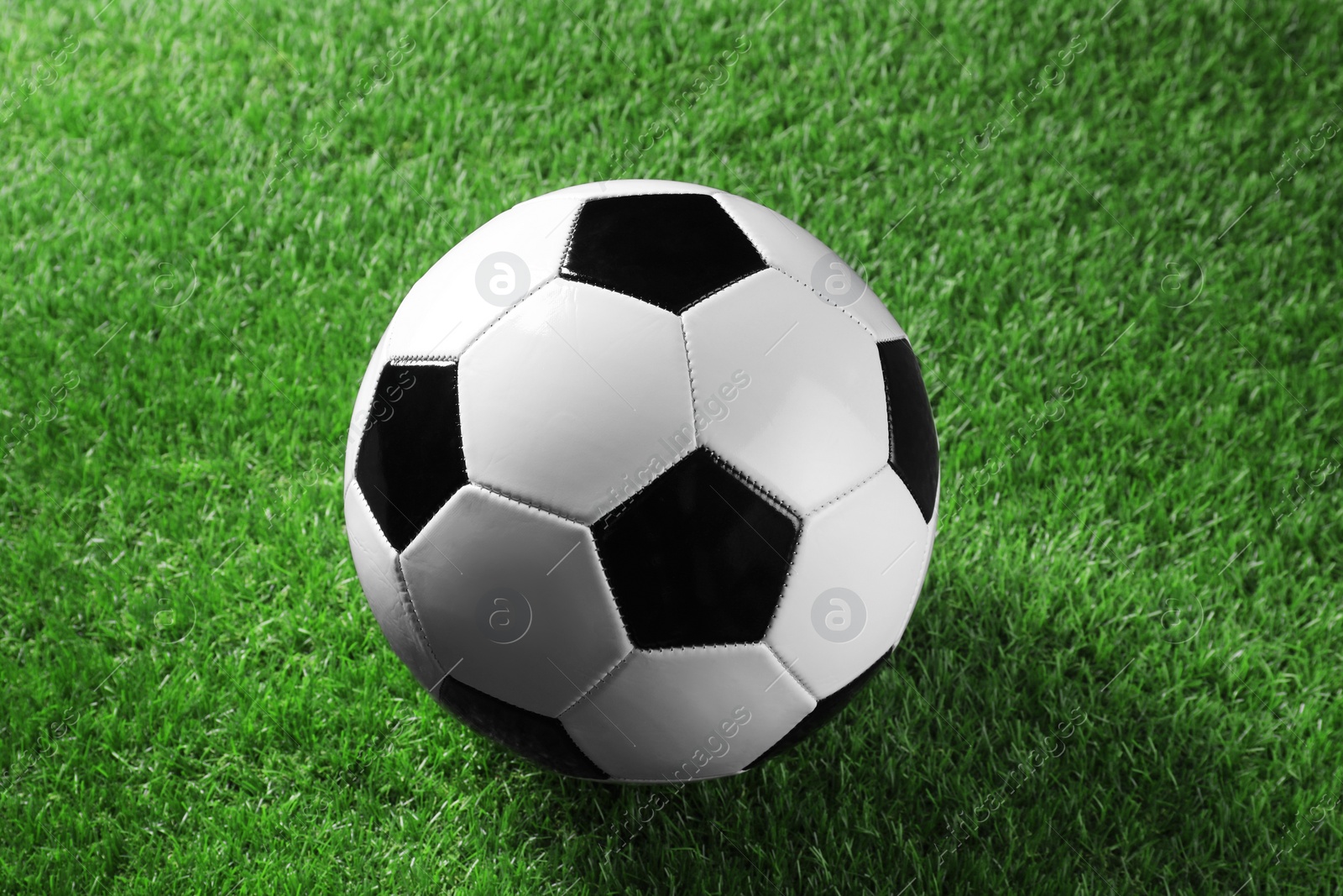 Photo of One soccer ball on green grass. Sports equipment