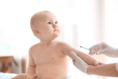 Photo of Doctor vaccinating baby in clinic