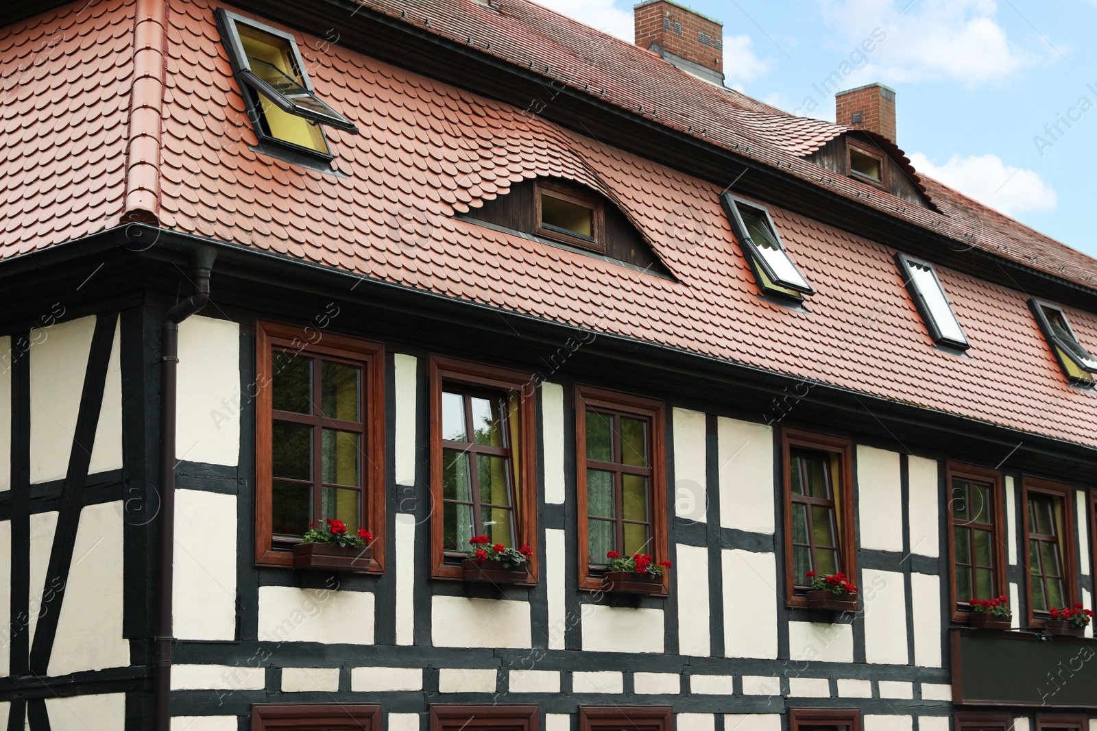 Photo of Stylish house with windows and brown roof