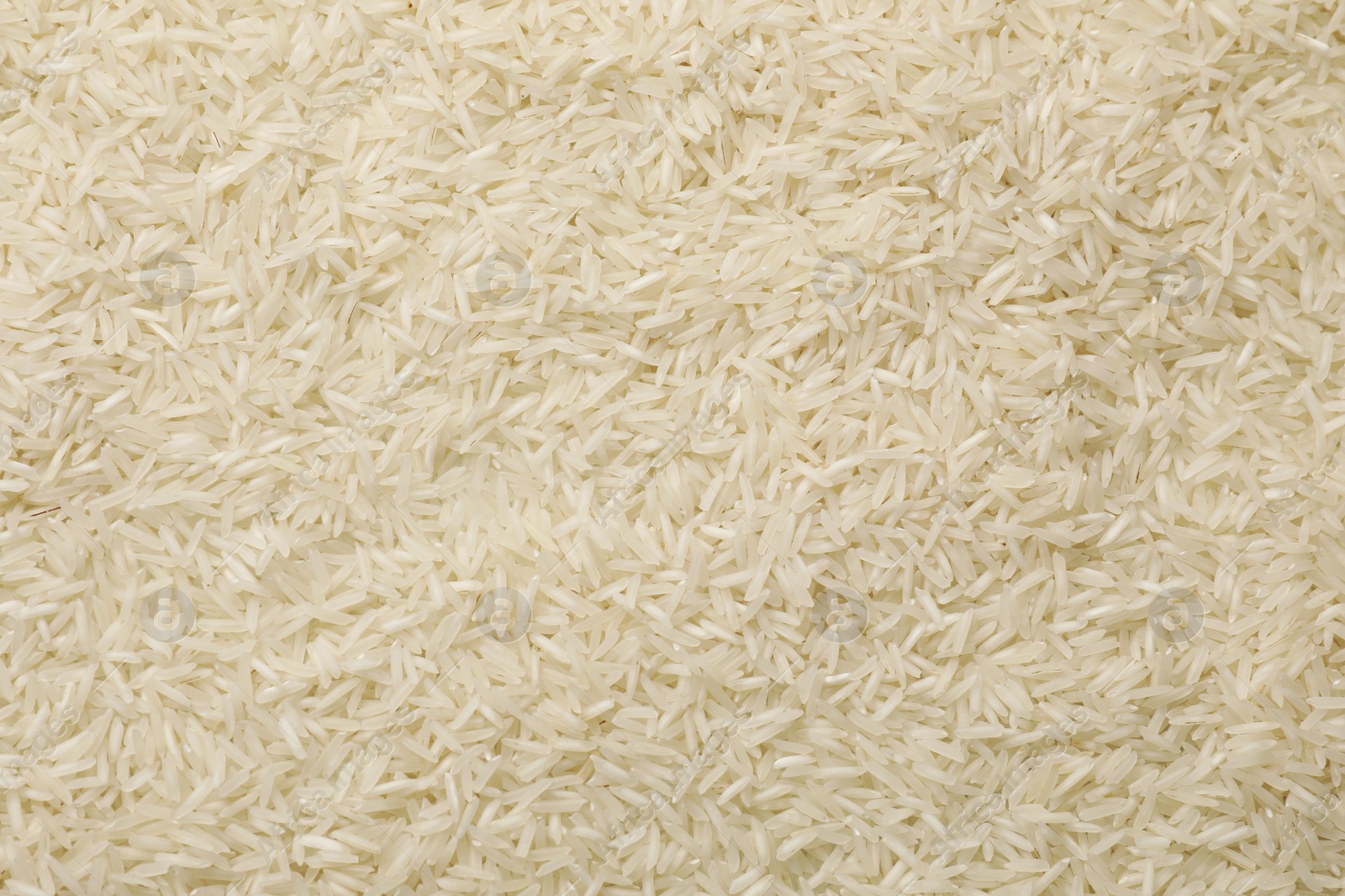 Photo of Raw basmati rice as background, top view