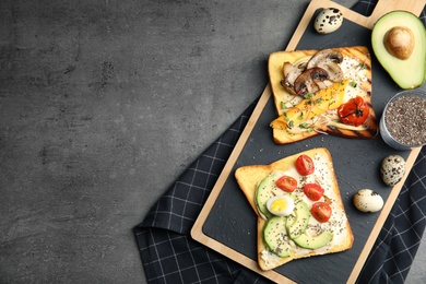 Photo of Different toasts with avocado, mushrooms, cherry tomatoes and chia seeds served on grey table, top view. Space for text