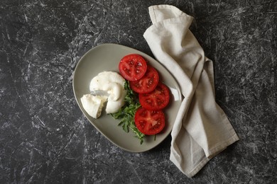 Delicious burrata cheese with tomatoes and arugula on grey table, flat lay