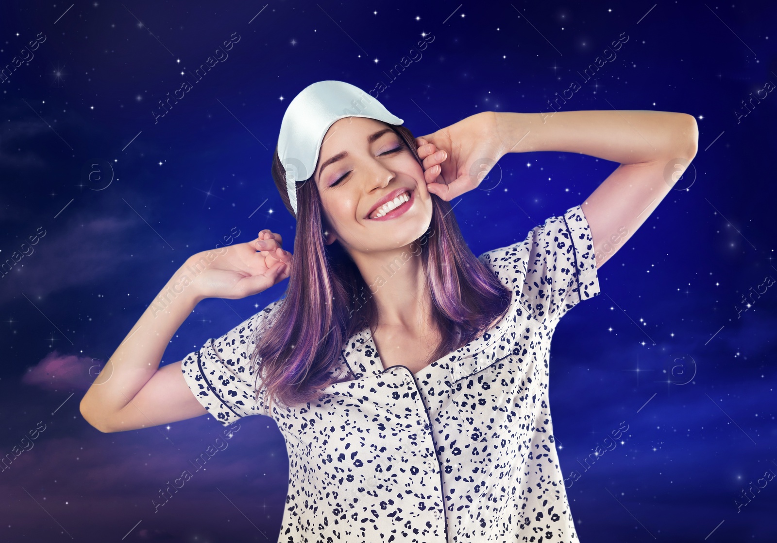 Image of Beautiful woman and night starry sky on background. Bedtime