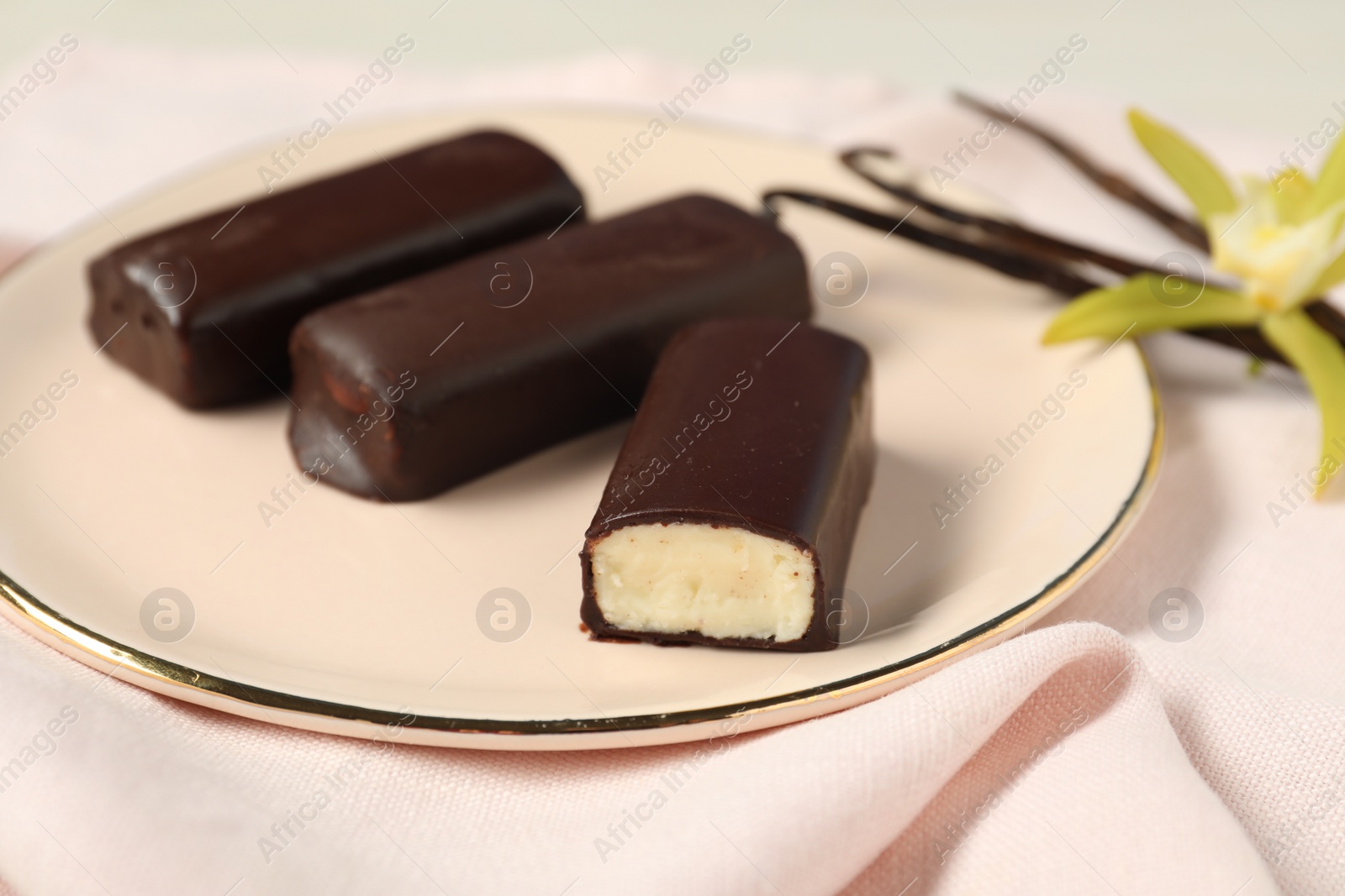 Photo of Glazed vanilla curd cheese bars served on table, closeup