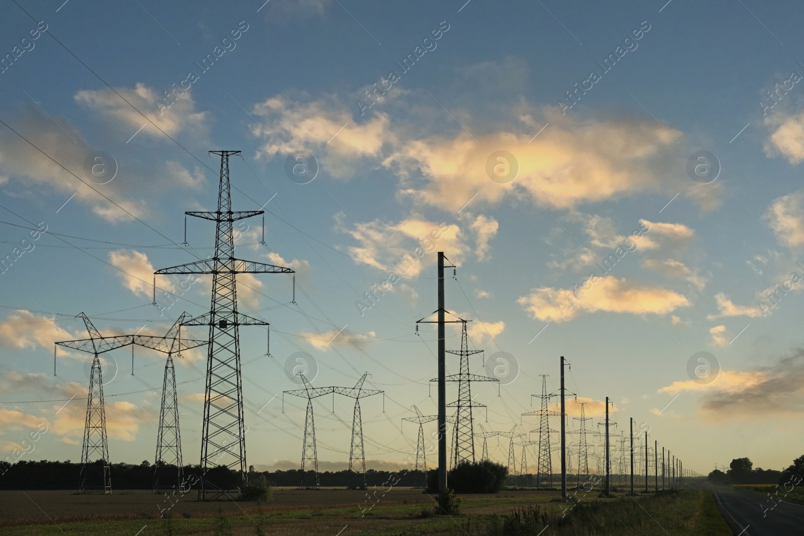 Photo of Telephone poles with cables under blue sky outdoors