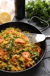 Tasty rice with shrimps and vegetables served on grey wooden table, closeup