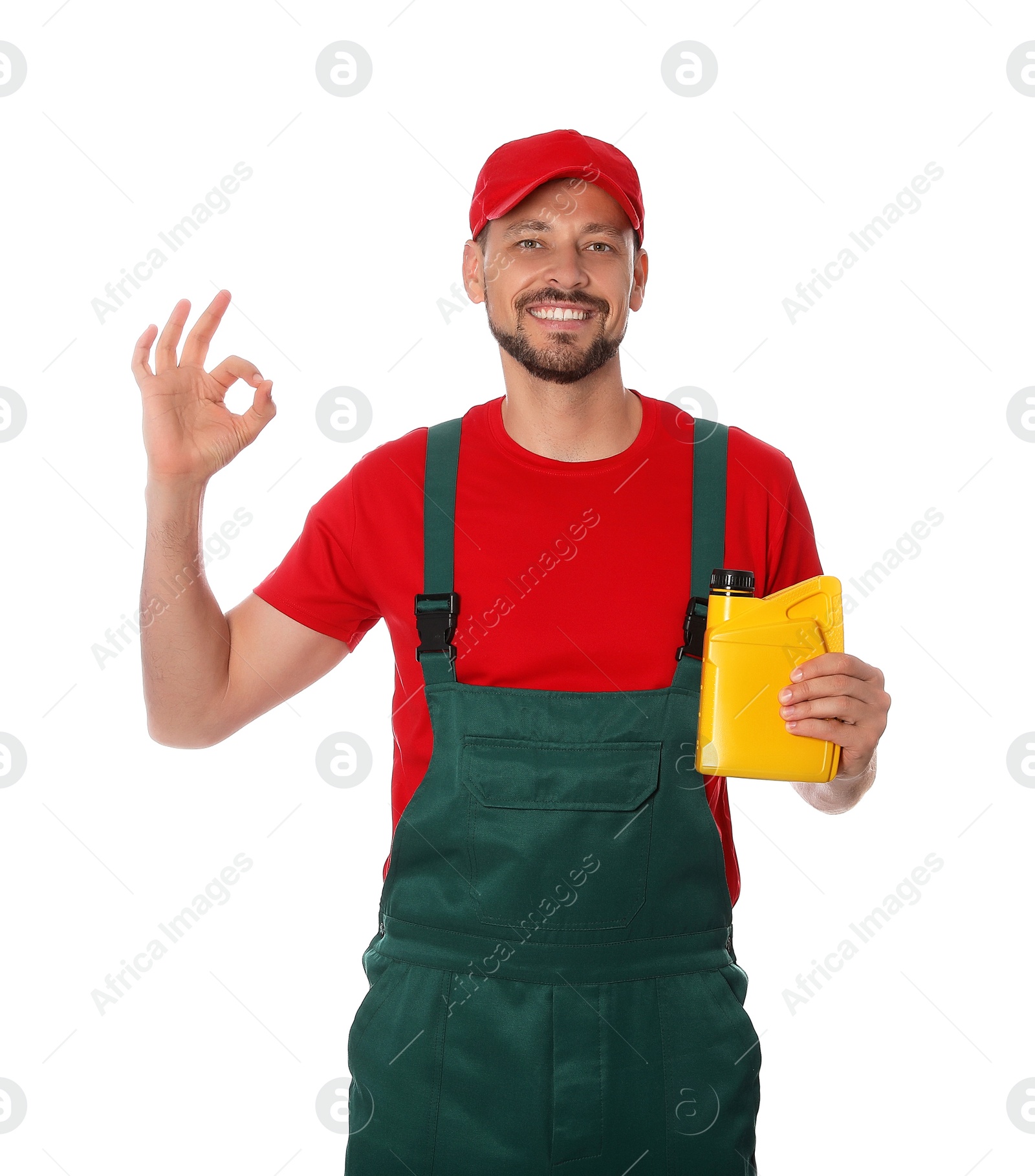 Photo of Man holding yellow container of motor oil and showing OK gesture on white background