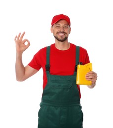 Photo of Man holding yellow container of motor oil and showing OK gesture on white background