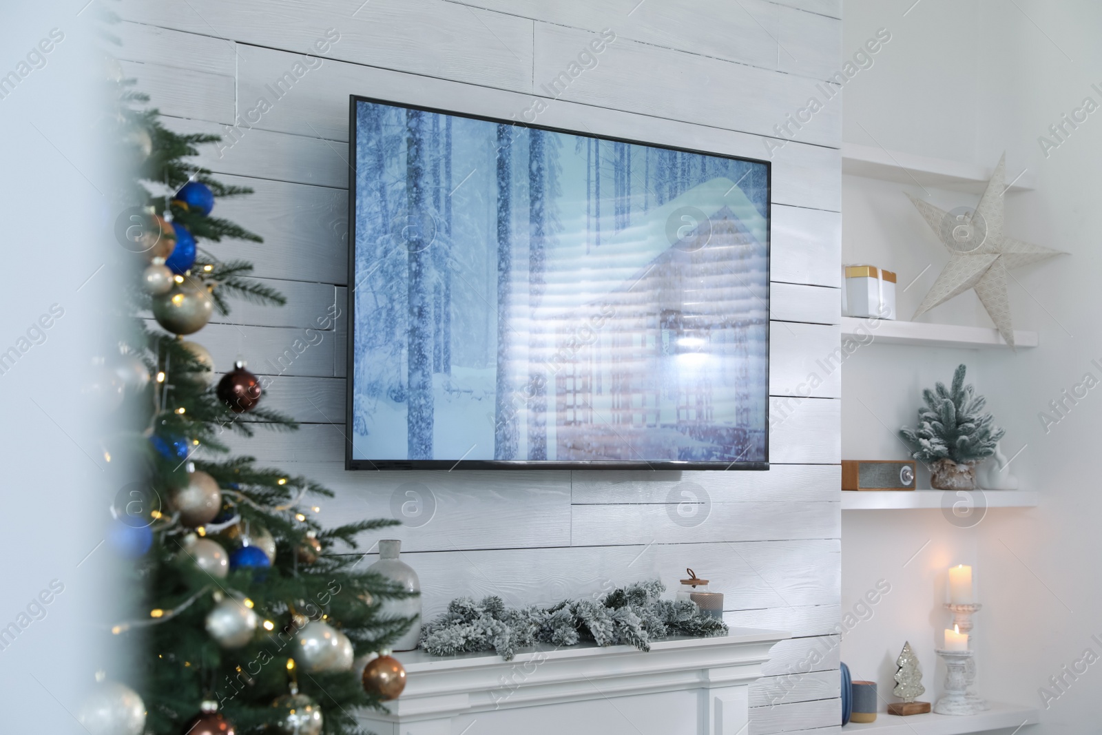 Photo of Stylish living room interior with modern TV and Christmas tree