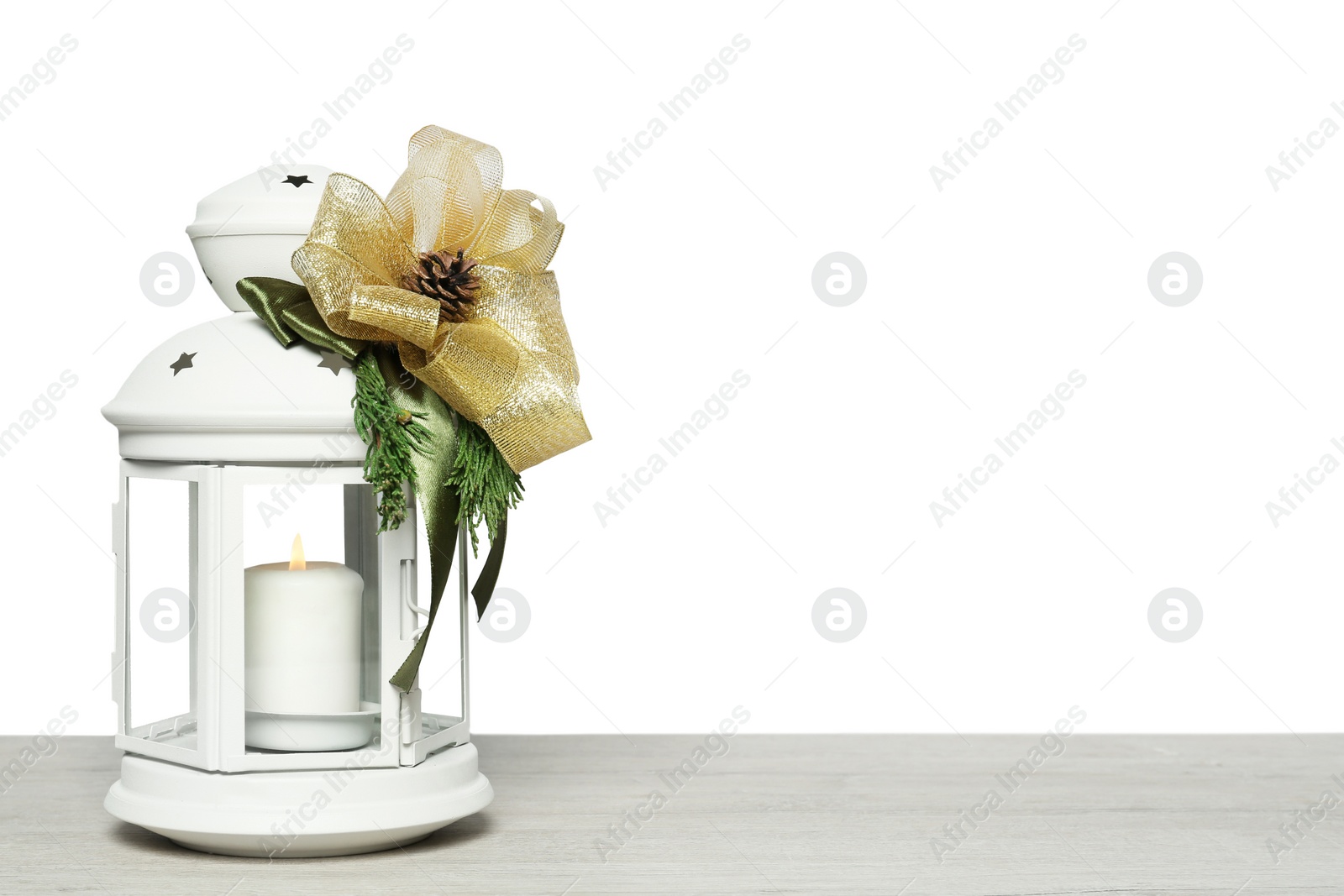 Photo of Decorative Christmas lantern with burning candle on wooden table. Space for text