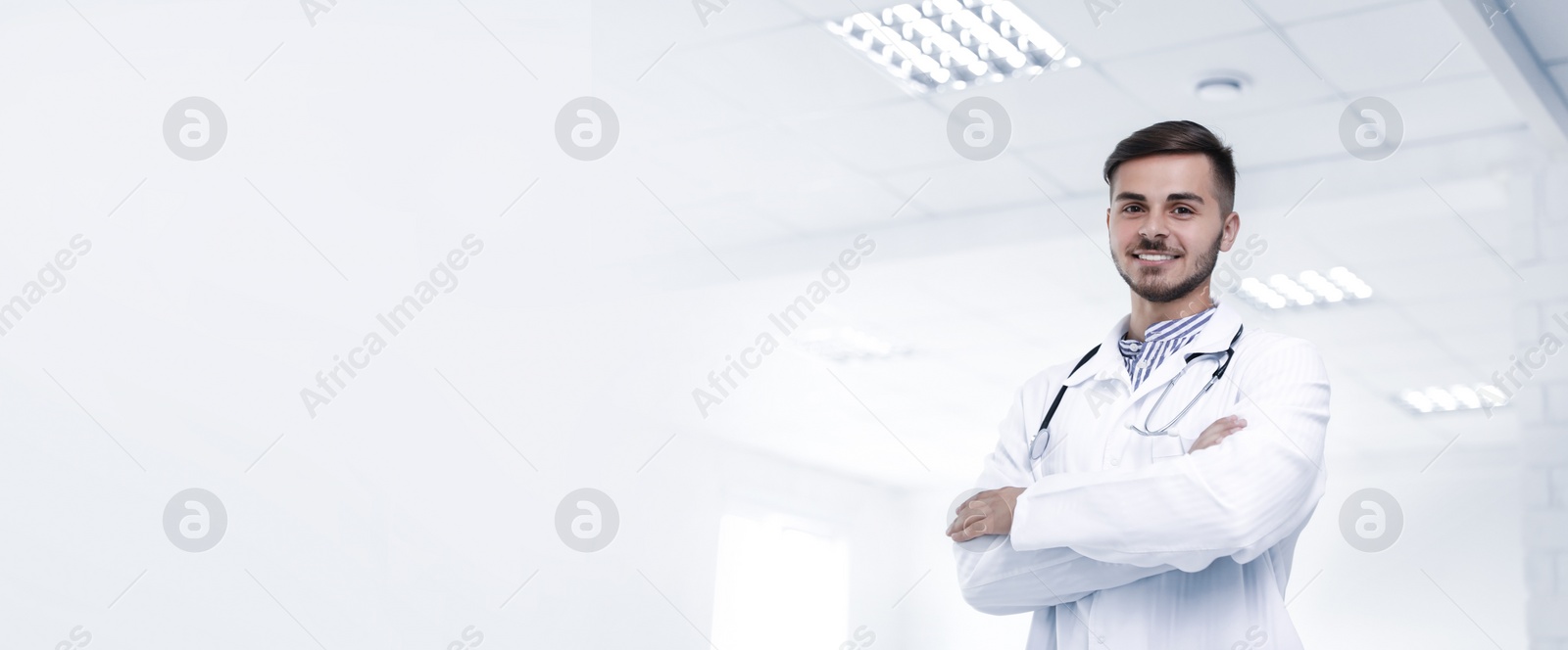 Image of Young doctor in uniform at workplace, space for text. Banner design