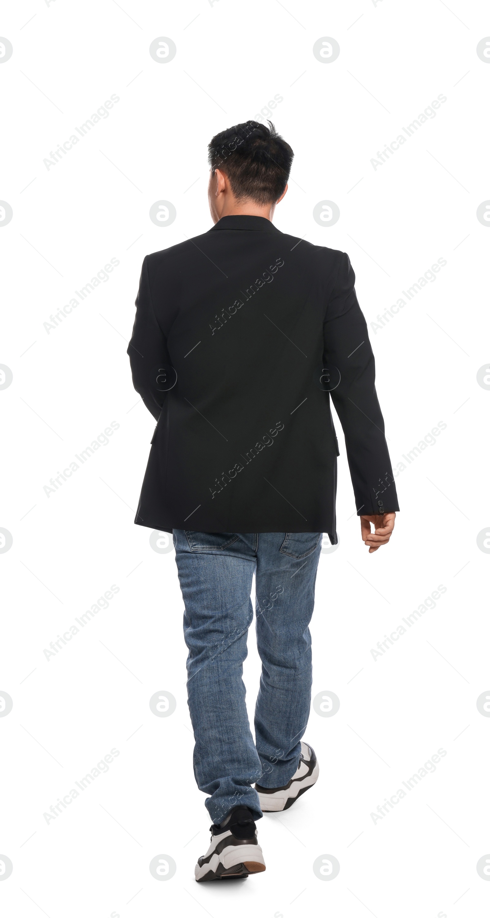 Photo of Man in casual outfit walking on white background, back view