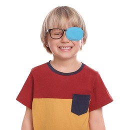 Photo of Happy boy with nozzle on glasses for treatment of strabismus on white background