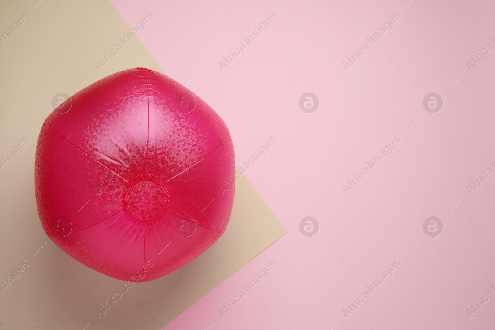 Photo of Bright beach ball on color background, top view. Space for text