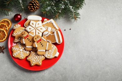 Flat lay composition with tasty homemade Christmas cookies on grey table, space for text