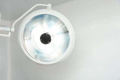 Powerful surgical lamp in modern operating room. Space for text