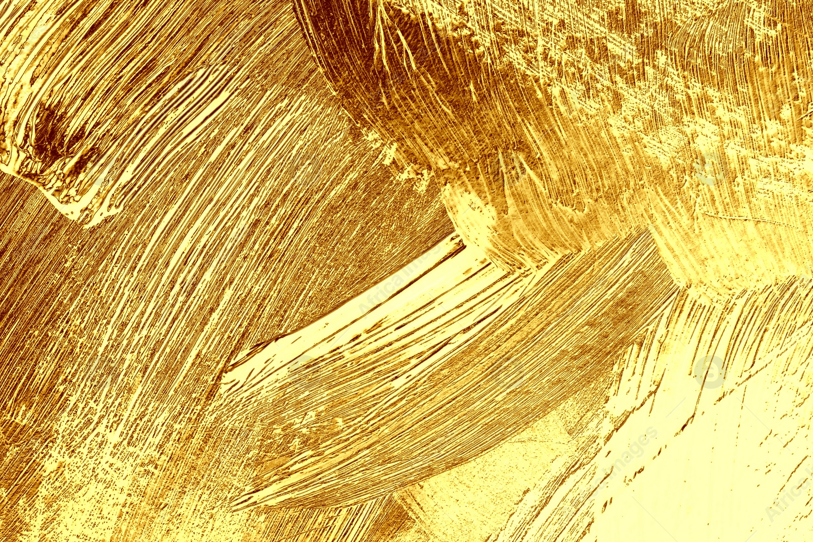 Image of Strokes of golden paint as background, closeup
