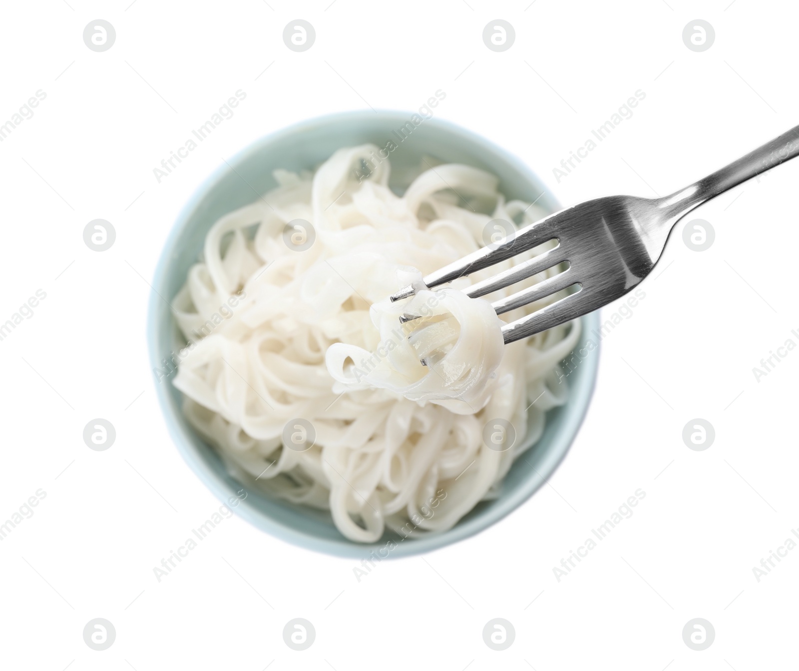 Photo of Fork with rice noodles over bowl on white background, top view