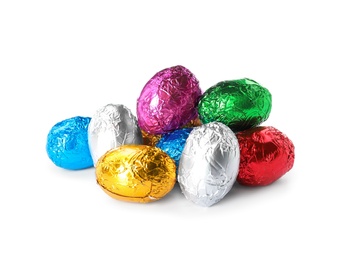 Chocolate eggs wrapped in colorful foil on white background