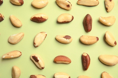 Flat lay composition with Brazil nuts on color background