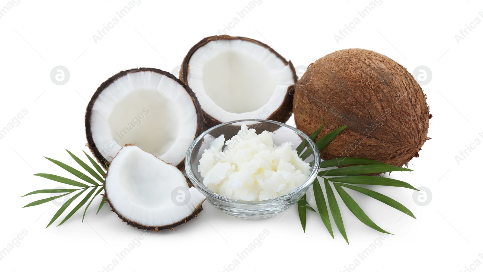 Photo of Organic coconut cooking oil, fresh fruits and leaves isolated on white