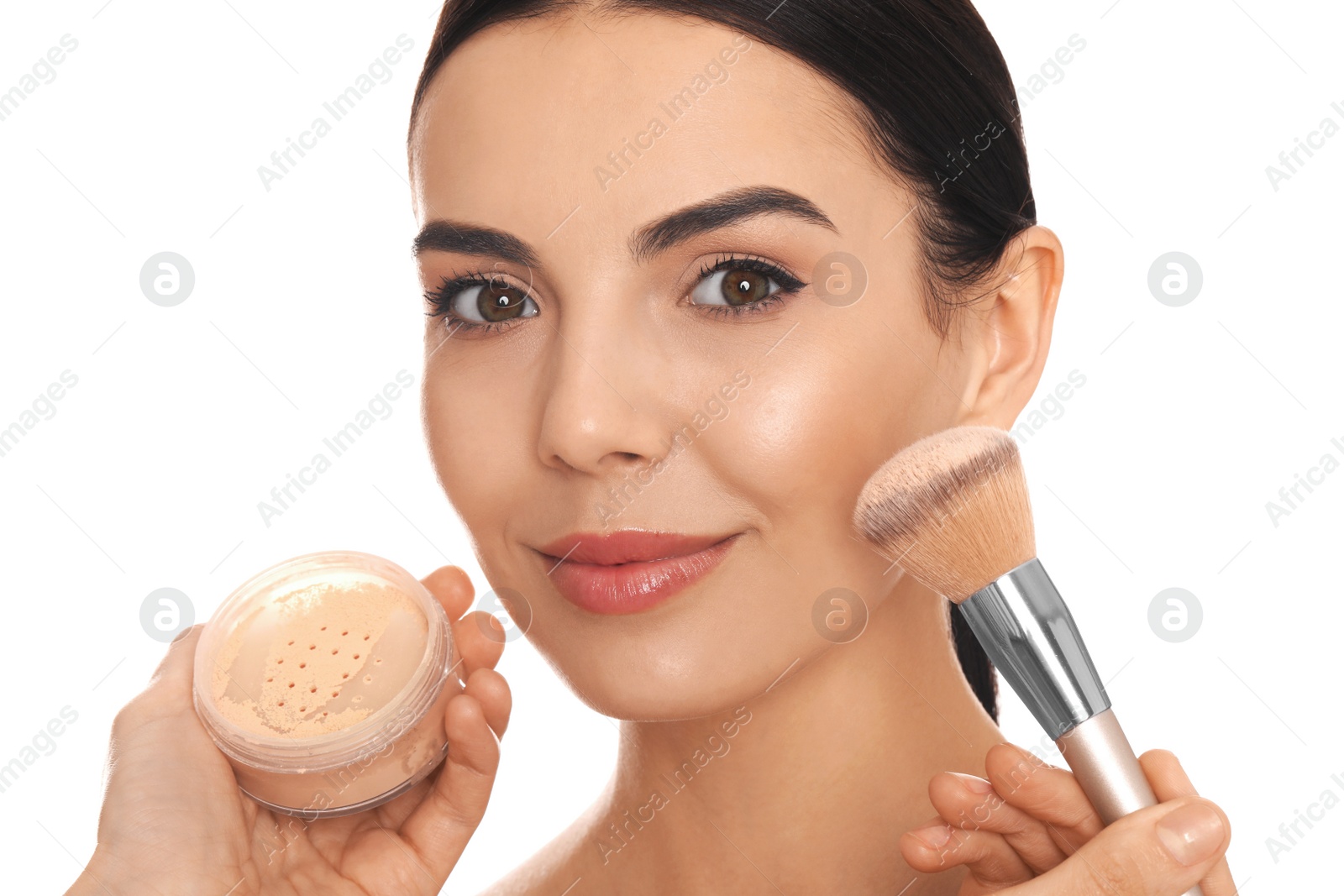 Photo of Professional makeup artist applying powder onto beautiful young woman's face with brush on white background, closeup