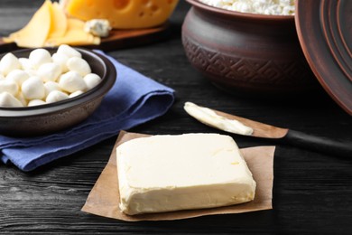 Photo of Clay dishware with fresh dairy products, focus on butter