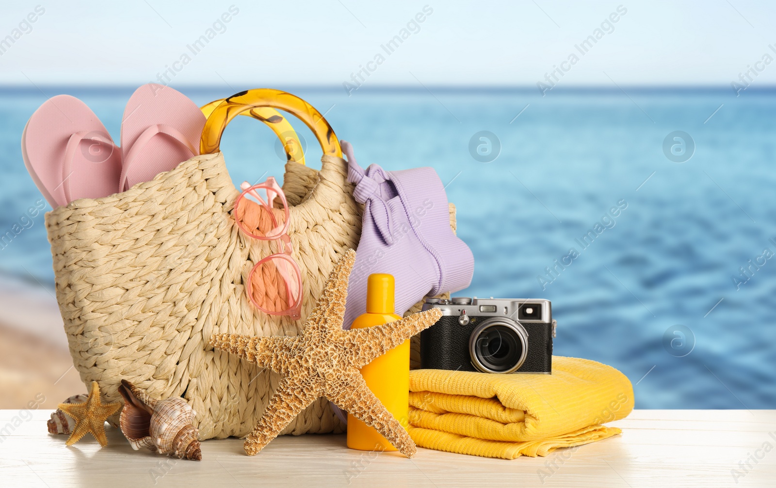 Image of Different beach objects on wooden surface near sea