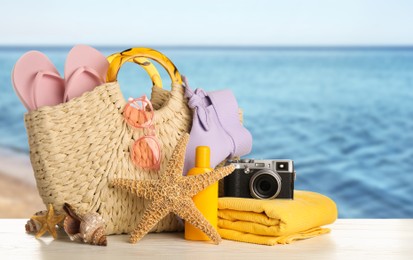 Image of Different beach objects on wooden surface near sea