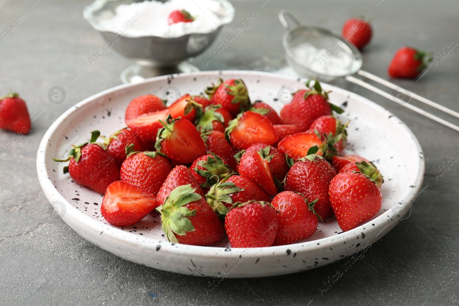 Photo of Plate with ripe red strawberries on table