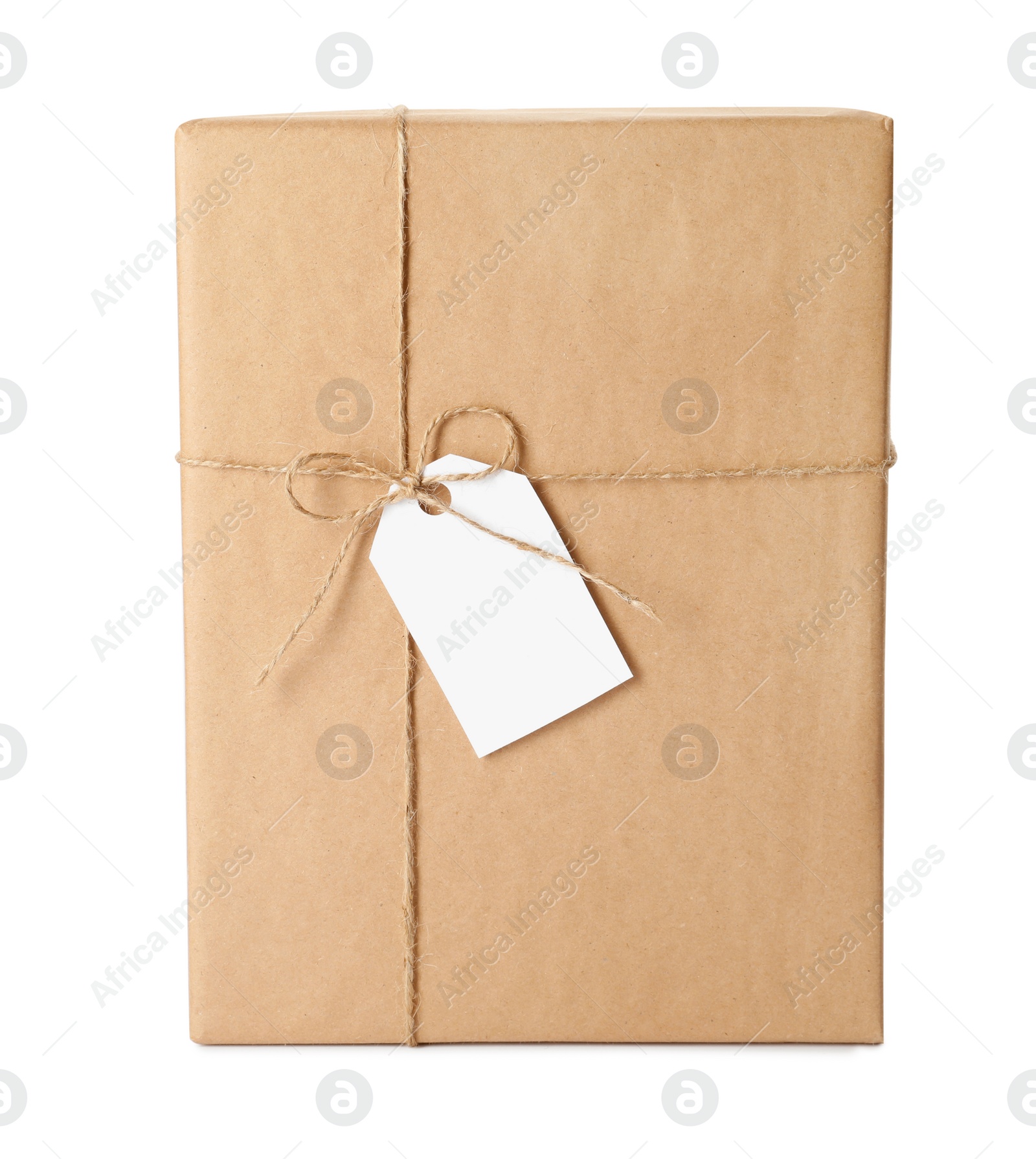 Photo of Gift box wrapped in kraft paper with bow and tag isolated on white