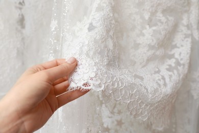 Young woman choosing wedding dress, closeup view