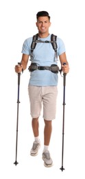 Male hiker with backpack and trekking poles on white background