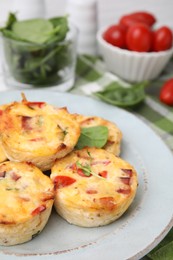 Delicious egg muffins with cheese and bacon on table, closeup. Space for text
